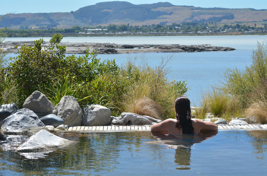 37197946 - young woman having a spa in outdoors hot pool in rotorua, new zealand.
